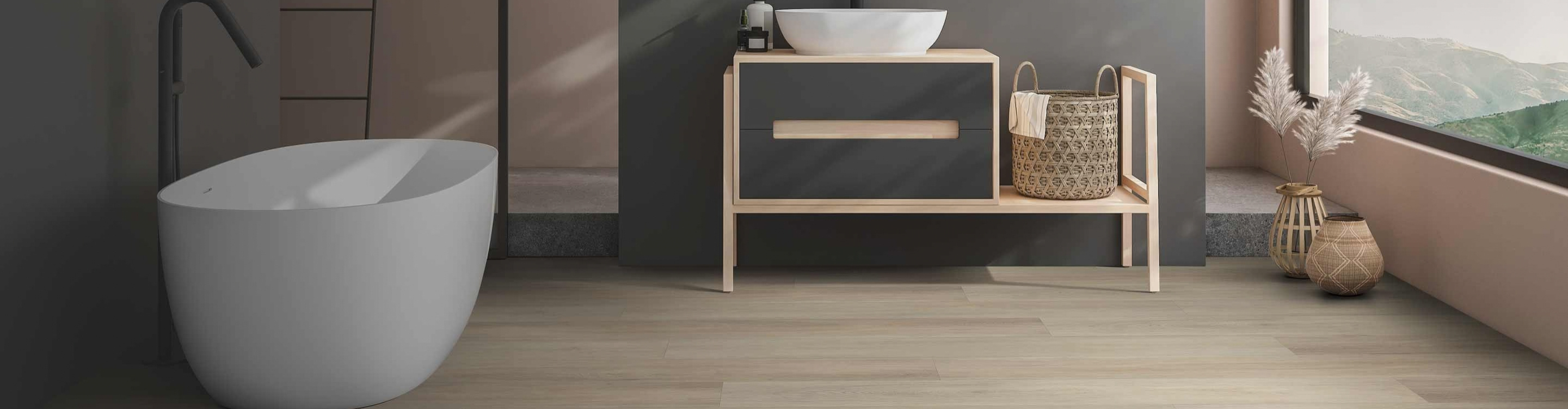 bathroom with waterproof flooring, a white freestanding sink, a light-wood vanity with drawers, neatly arranged towels and decor, and a small window view with greenery.